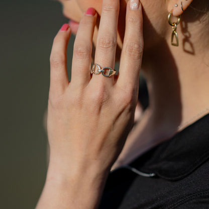 Photo of a horse rider wearing a silver horse bit snaffle ring made by Crawford Hill Equestrian Jewellery.